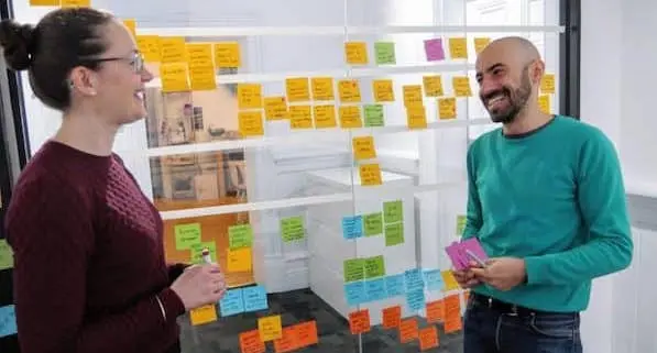 Mario and Eadaoin in front of a wall full of sticky notes