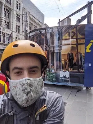 Mario doing research in front of an information booth in Melbourne